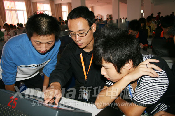 在新校區,老師指導學子上機